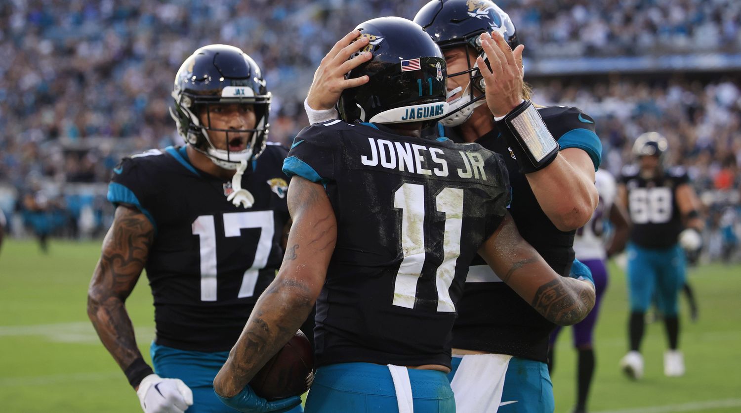 Jacksonville Jaguars tight end Evan Engram celebrates with wide receiver Marvin Jones Jr.'s, who is being hugged by quarterback Trevor Lawrence